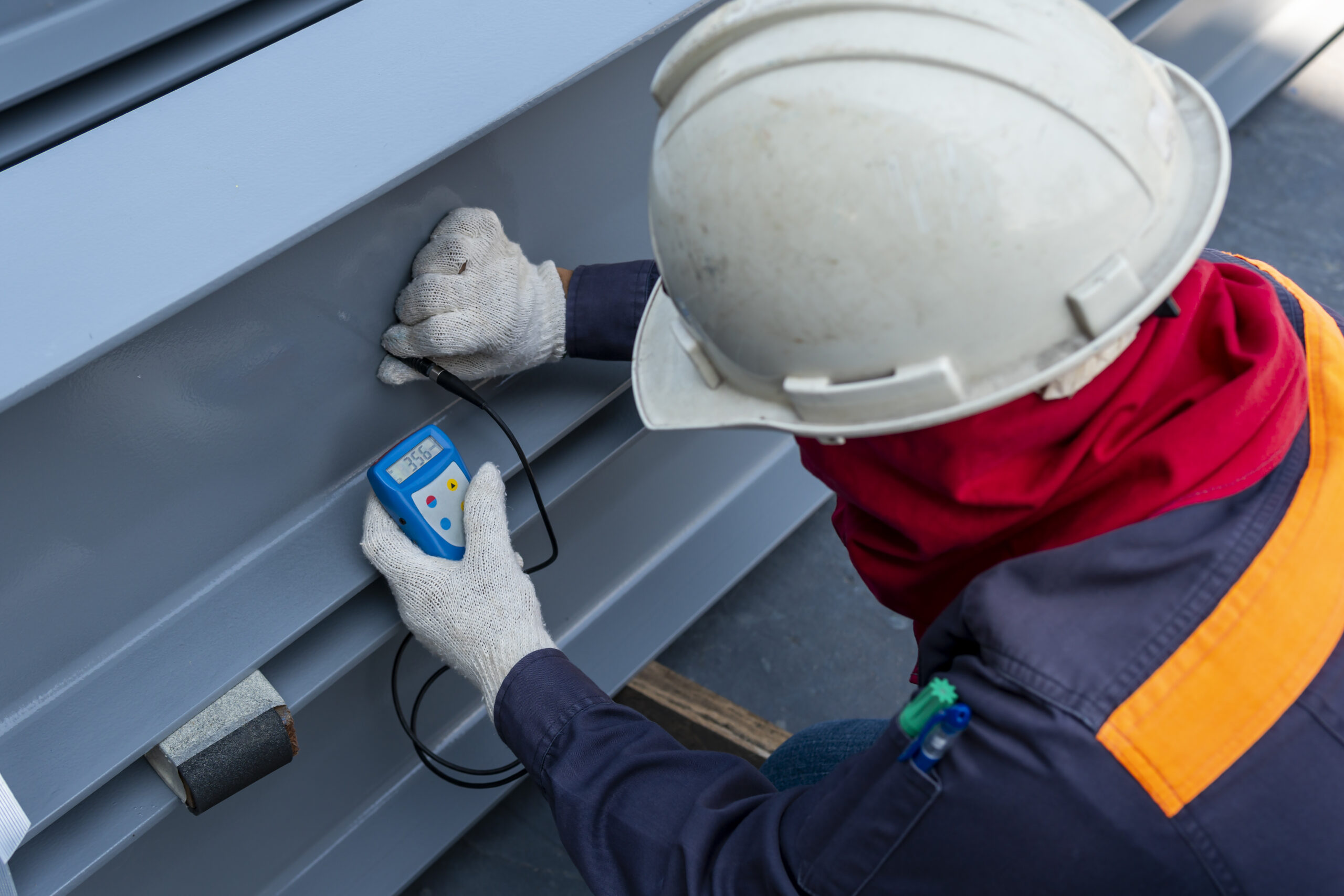 Technicians are measuring the Dry Film Thickness (DFT) with Coat